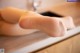 A close up of a person's foot on a sink.